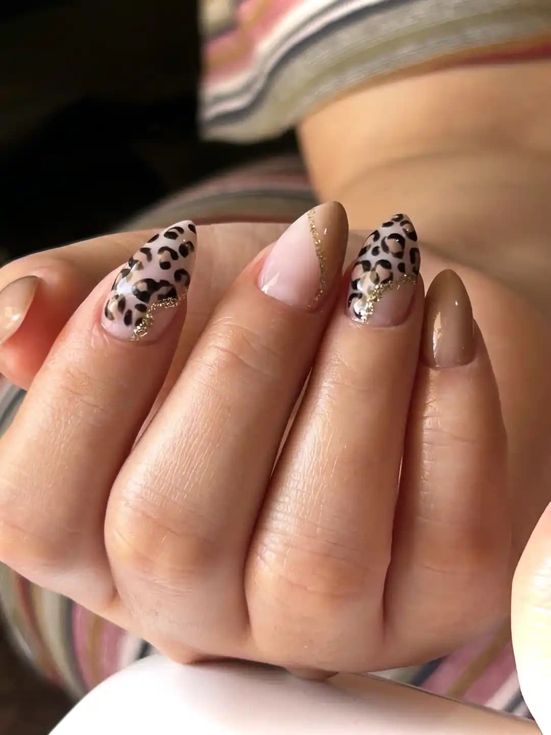 Leopard accent gold-line manicure setup